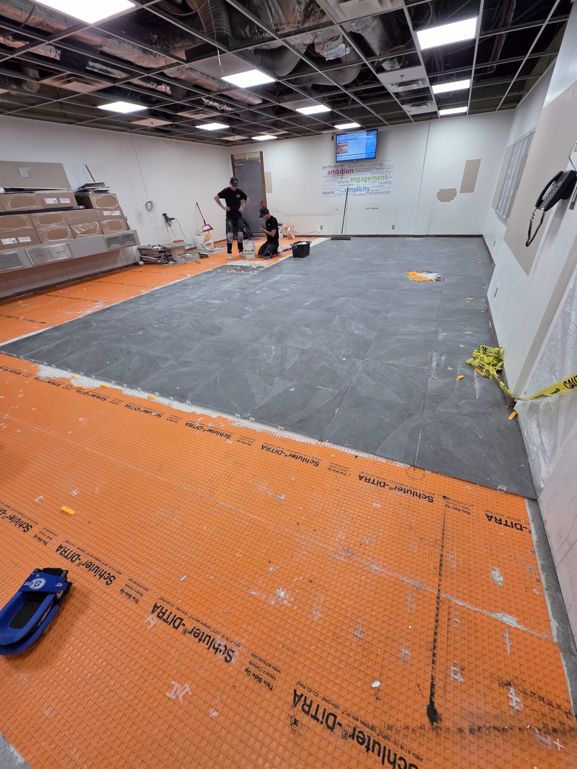 24x24 tile being installed on a commercial project services